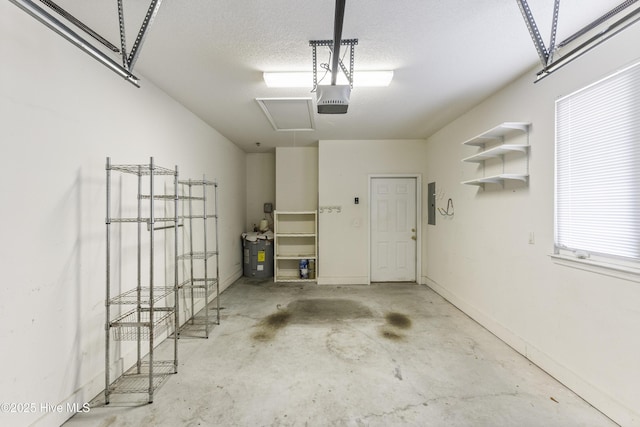 garage featuring electric panel and a garage door opener