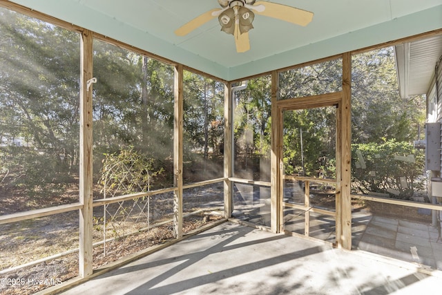 unfurnished sunroom with ceiling fan