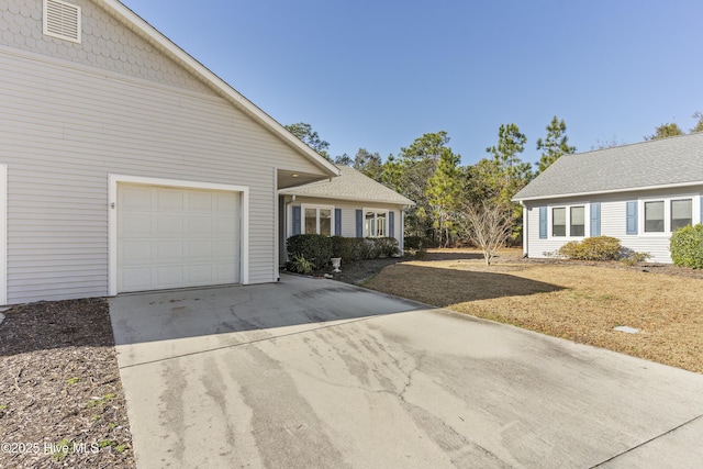 view of side of property with a garage and a yard