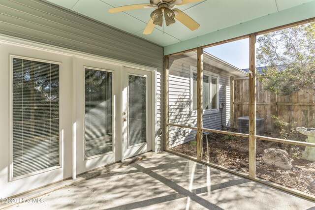 unfurnished sunroom featuring ceiling fan