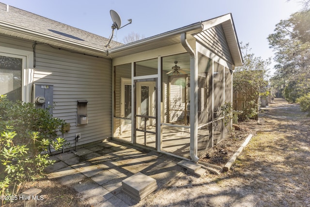 view of property exterior with a patio, ceiling fan, and a sunroom