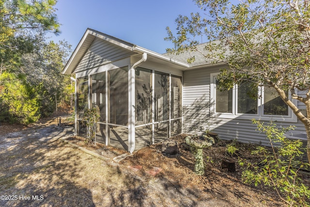 view of side of property featuring a sunroom