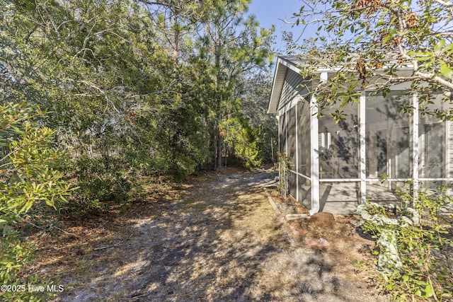 view of property exterior featuring a sunroom