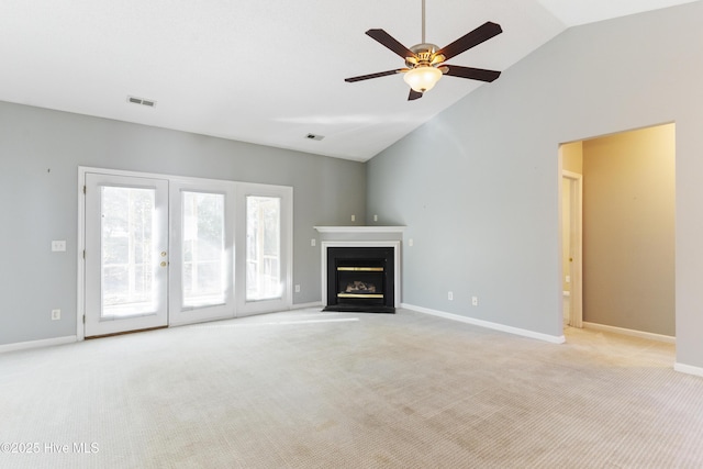 unfurnished living room featuring ceiling fan, lofted ceiling, and light carpet