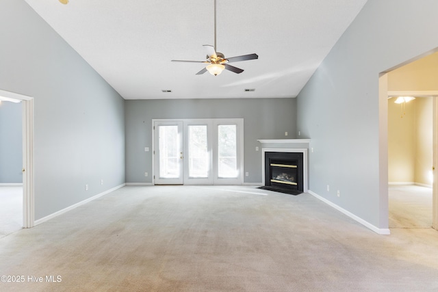 unfurnished living room featuring light carpet and ceiling fan