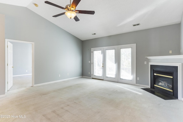 unfurnished living room featuring ceiling fan, light carpet, and vaulted ceiling