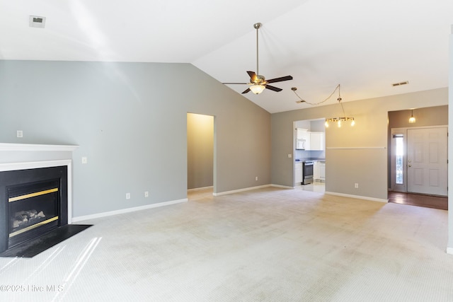 unfurnished living room featuring ceiling fan, light carpet, and vaulted ceiling