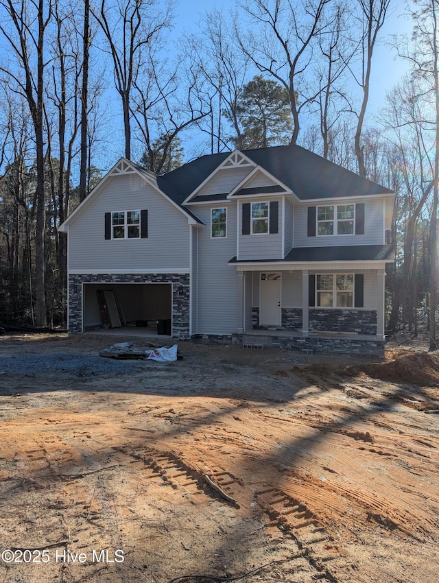 front of property with covered porch and a garage