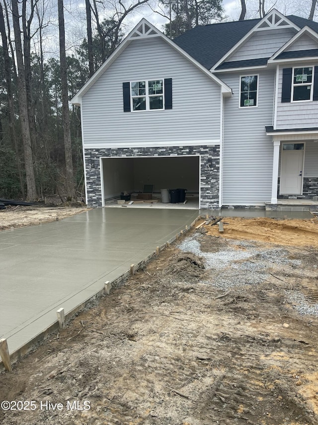 front of property featuring a porch and a garage