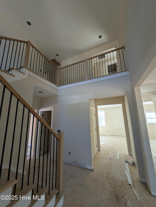 stairs featuring a high ceiling