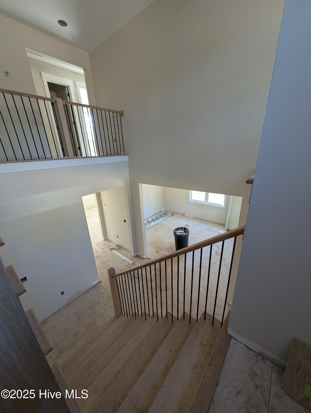 staircase with a towering ceiling