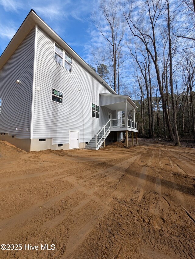 rear view of property with a wooden deck