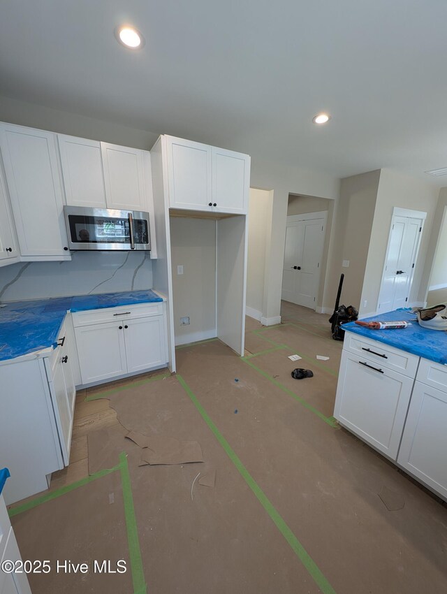 spare room featuring coffered ceiling and beamed ceiling