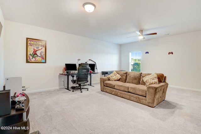 carpeted home office featuring ceiling fan