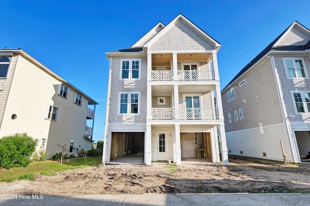 view of front facade featuring a garage and a balcony