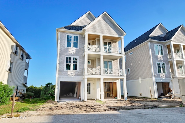 view of front of home with a balcony and a garage