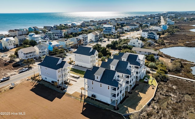 drone / aerial view with a residential view and a water view