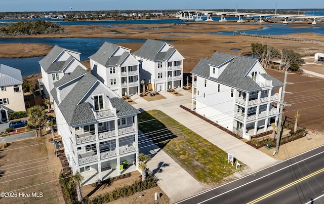 birds eye view of property featuring a water view and a residential view