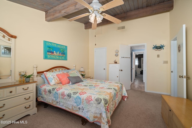 bedroom with visible vents, beam ceiling, wood ceiling, and light colored carpet