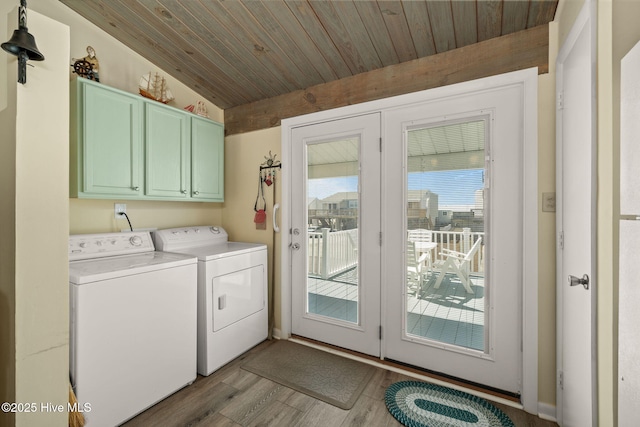 clothes washing area with cabinet space, wood ceiling, separate washer and dryer, and light wood-style floors