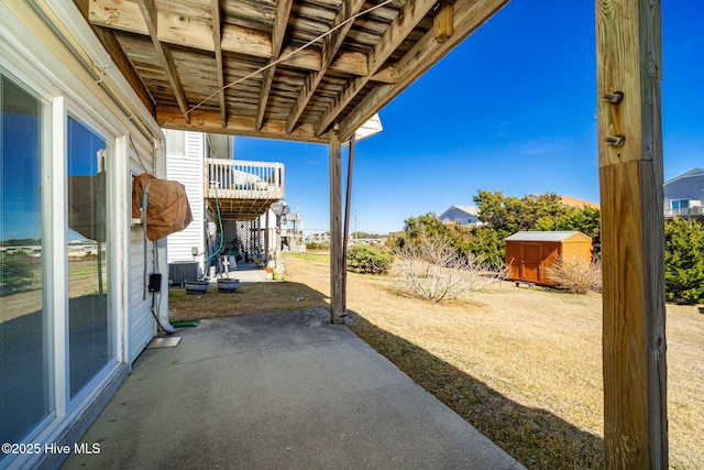 view of patio / terrace featuring an outbuilding and a storage shed