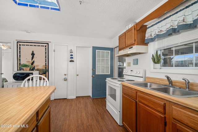 kitchen with electric range, brown cabinets, light countertops, under cabinet range hood, and a sink