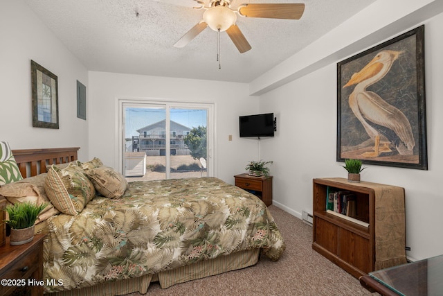 carpeted bedroom featuring access to exterior, a baseboard heating unit, a textured ceiling, and a ceiling fan