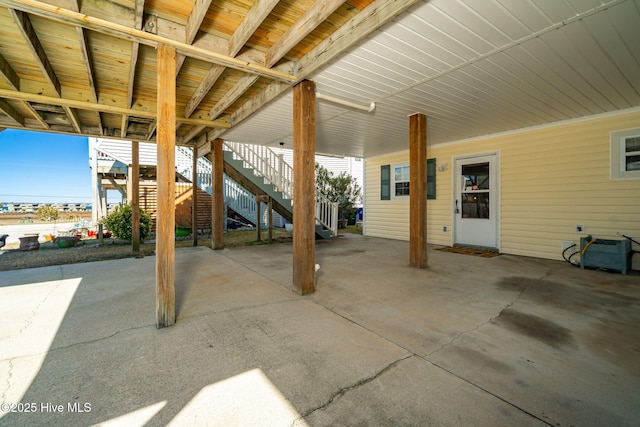 view of patio / terrace with stairs and a carport