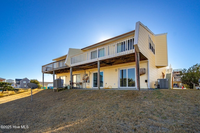 back of house with a deck, a yard, and cooling unit