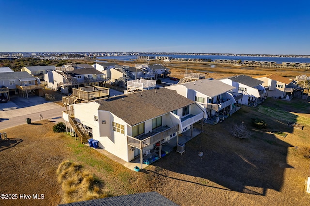 birds eye view of property with a water view and a residential view