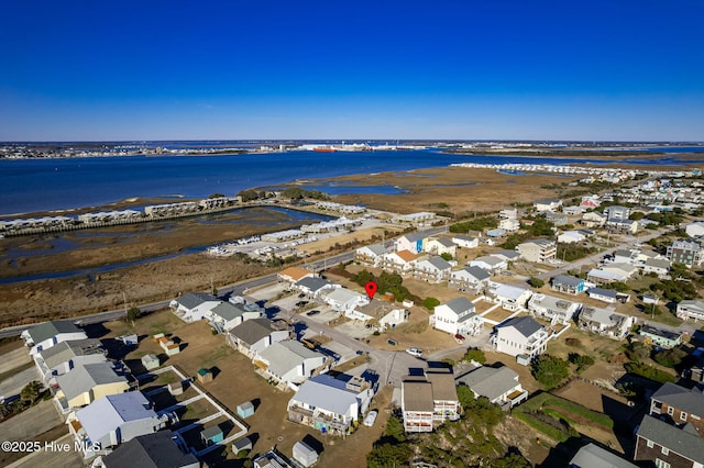 drone / aerial view featuring a water view and a residential view