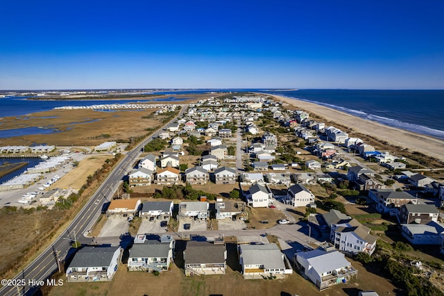 bird's eye view with a residential view, a water view, and a beach view