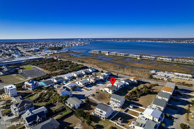 drone / aerial view with a water view and a residential view