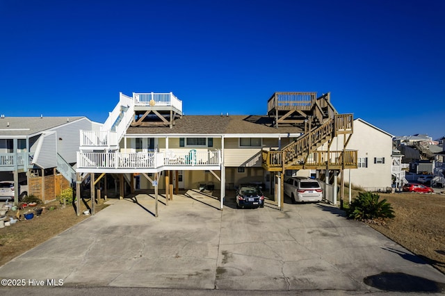 exterior space featuring a shingled roof, a residential view, and stairway