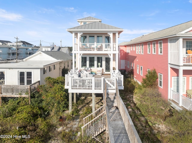 back of house featuring a balcony