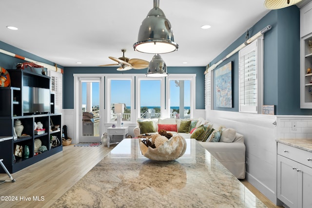 living room featuring ceiling fan and light hardwood / wood-style floors