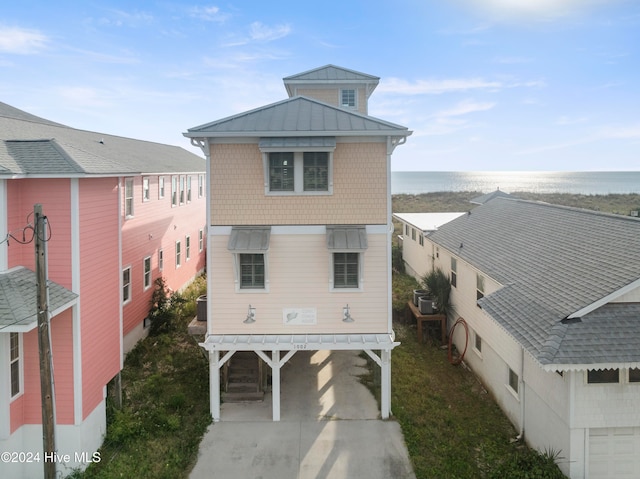 back of house featuring a water view and a carport