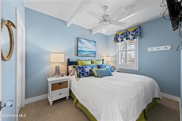 bedroom with ceiling fan, beamed ceiling, and carpet floors