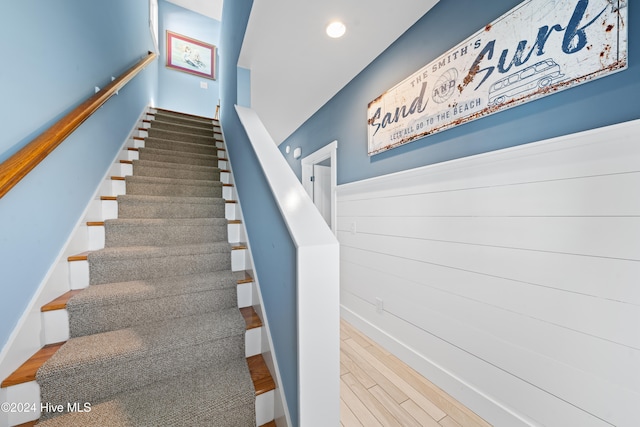 stairway with hardwood / wood-style floors