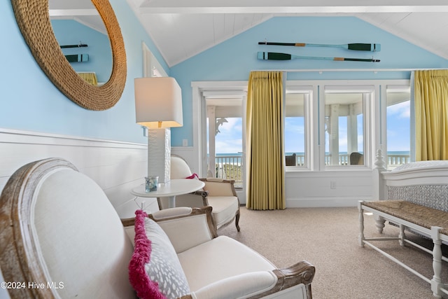 living area with vaulted ceiling with beams and carpet floors