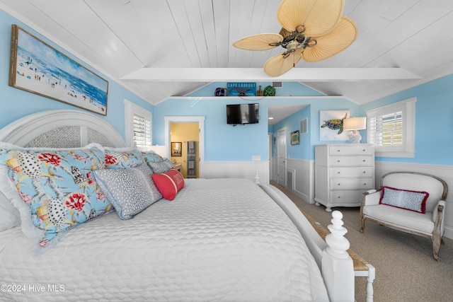 carpeted bedroom featuring lofted ceiling with beams, ceiling fan, and wooden ceiling