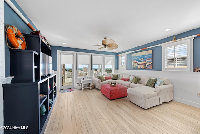 living room with ceiling fan and light hardwood / wood-style flooring