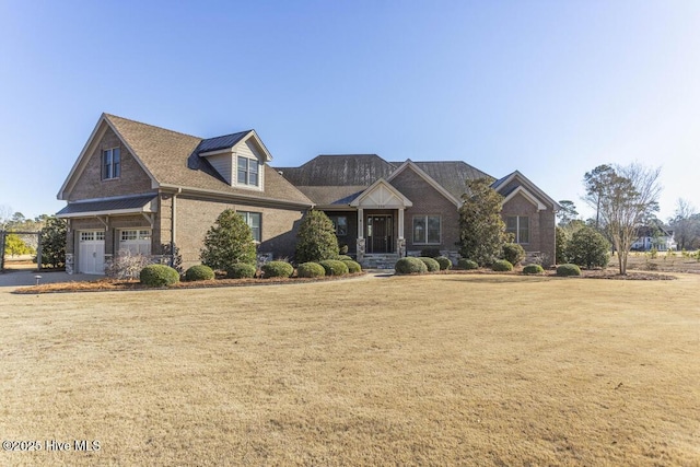 view of front of property with a garage and a front yard