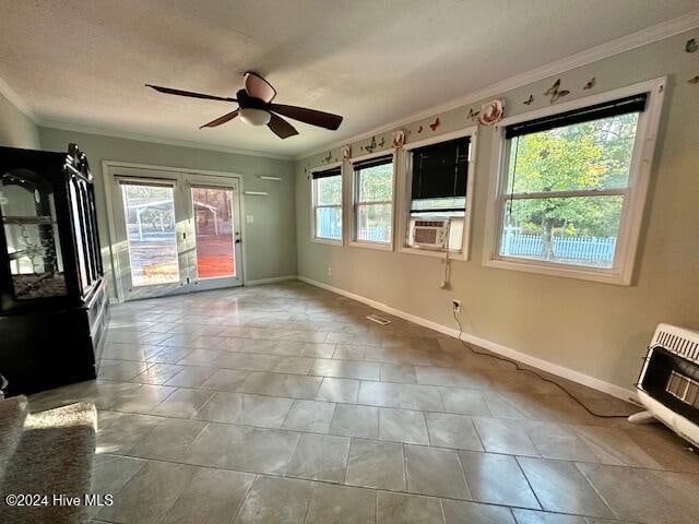 interior space featuring heating unit, plenty of natural light, and ornamental molding