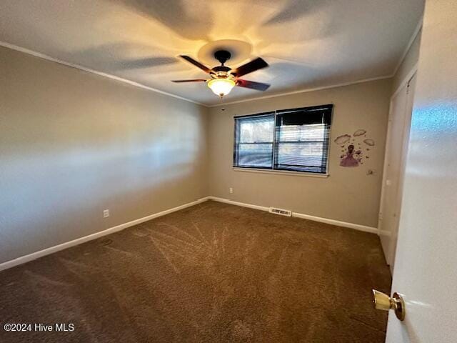 carpeted empty room featuring ceiling fan and ornamental molding