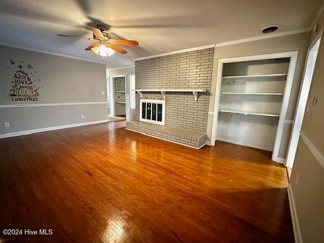 unfurnished living room featuring hardwood / wood-style flooring, ceiling fan, ornamental molding, and a brick fireplace