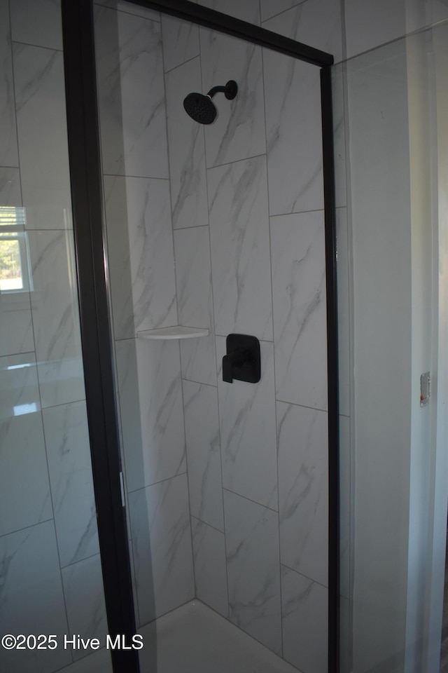 bathroom with tiled shower