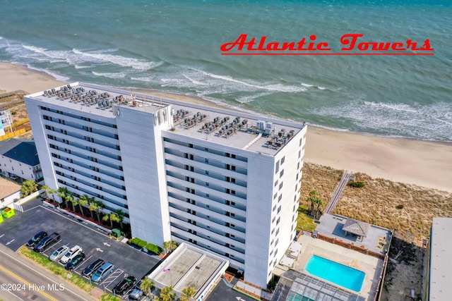 birds eye view of property with a water view and a view of the beach