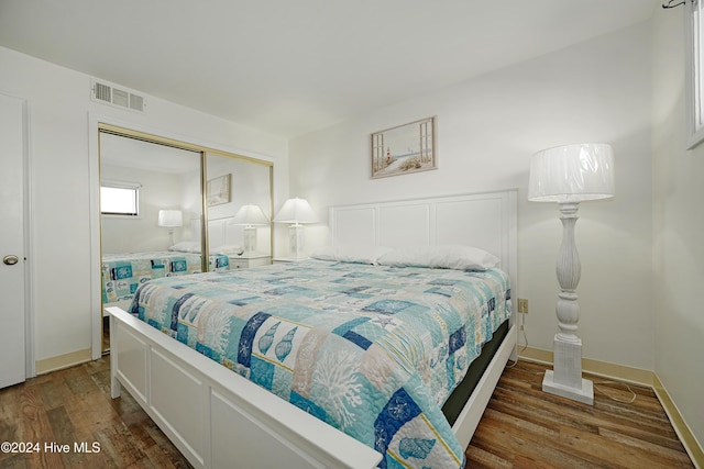 1615 Lake Park Blvd S Unit 1007, Carolina Beach, NC 28428 - bedroom featuring wood finished floors, a closet, and baseboards