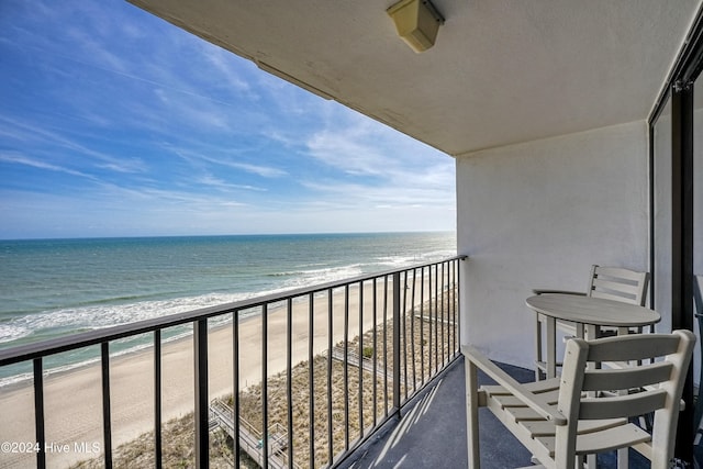 balcony with a view of the beach and a water view